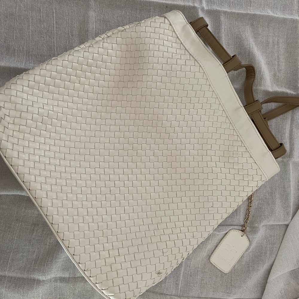 White and tan woven Arbonne backpack purse